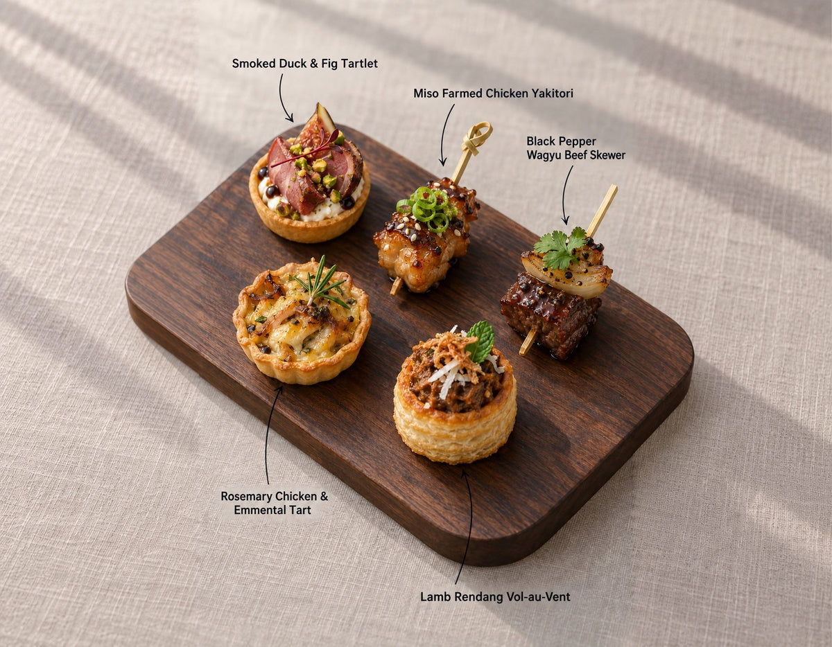 Fire & Grill canapes on a wooden board, labelled Smoked Duck & Fig Tartlet and 4 more. Cuseho canape catering, Singapore