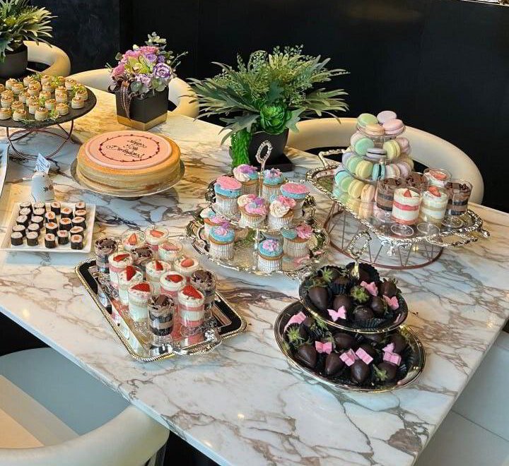 Dessert table with macarons, cupcakes, dessert cups and chocolate strawberries. Cuseho desserts live station catering, Singapore