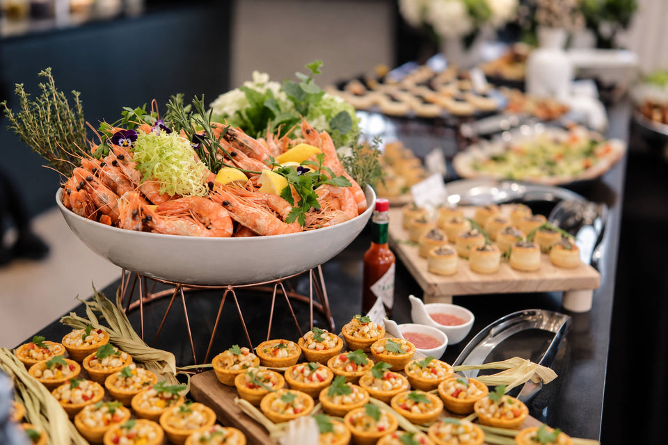 Tiger prawns and filled pastry cups at a seafood station. Cuseho appetisers live station catering, Singapore