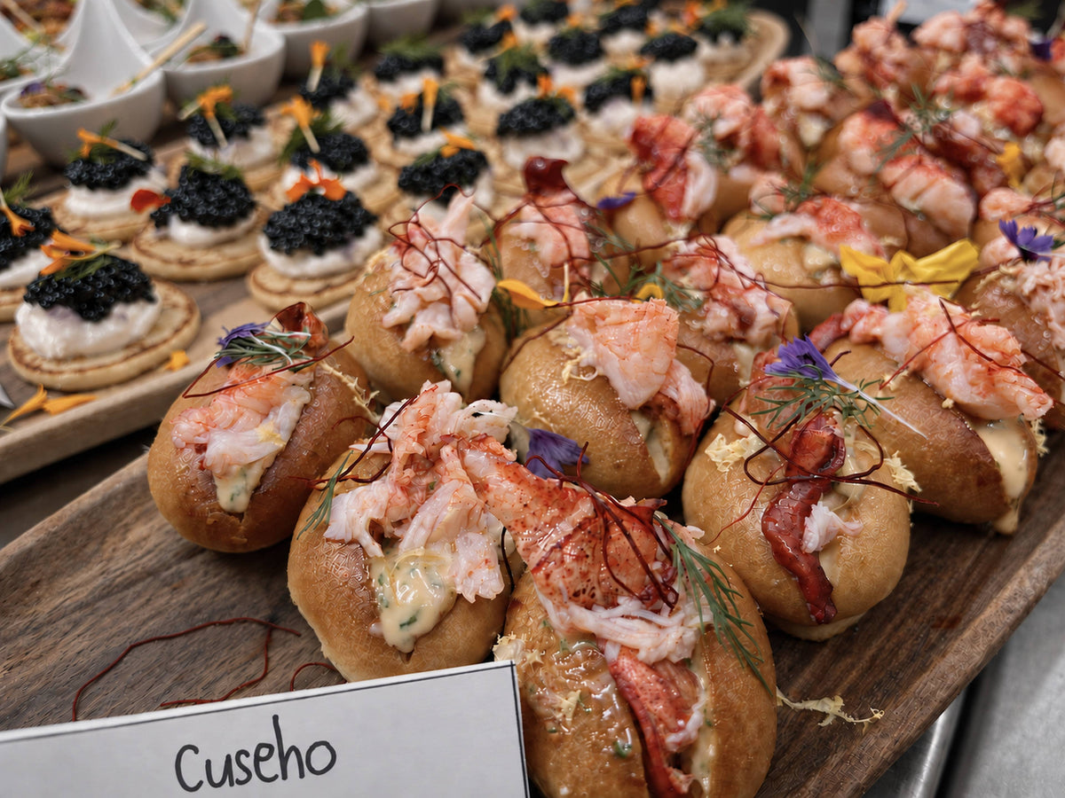 Mini lobster rolls on a wooden board. Cuseho mains live station catering, Singapore