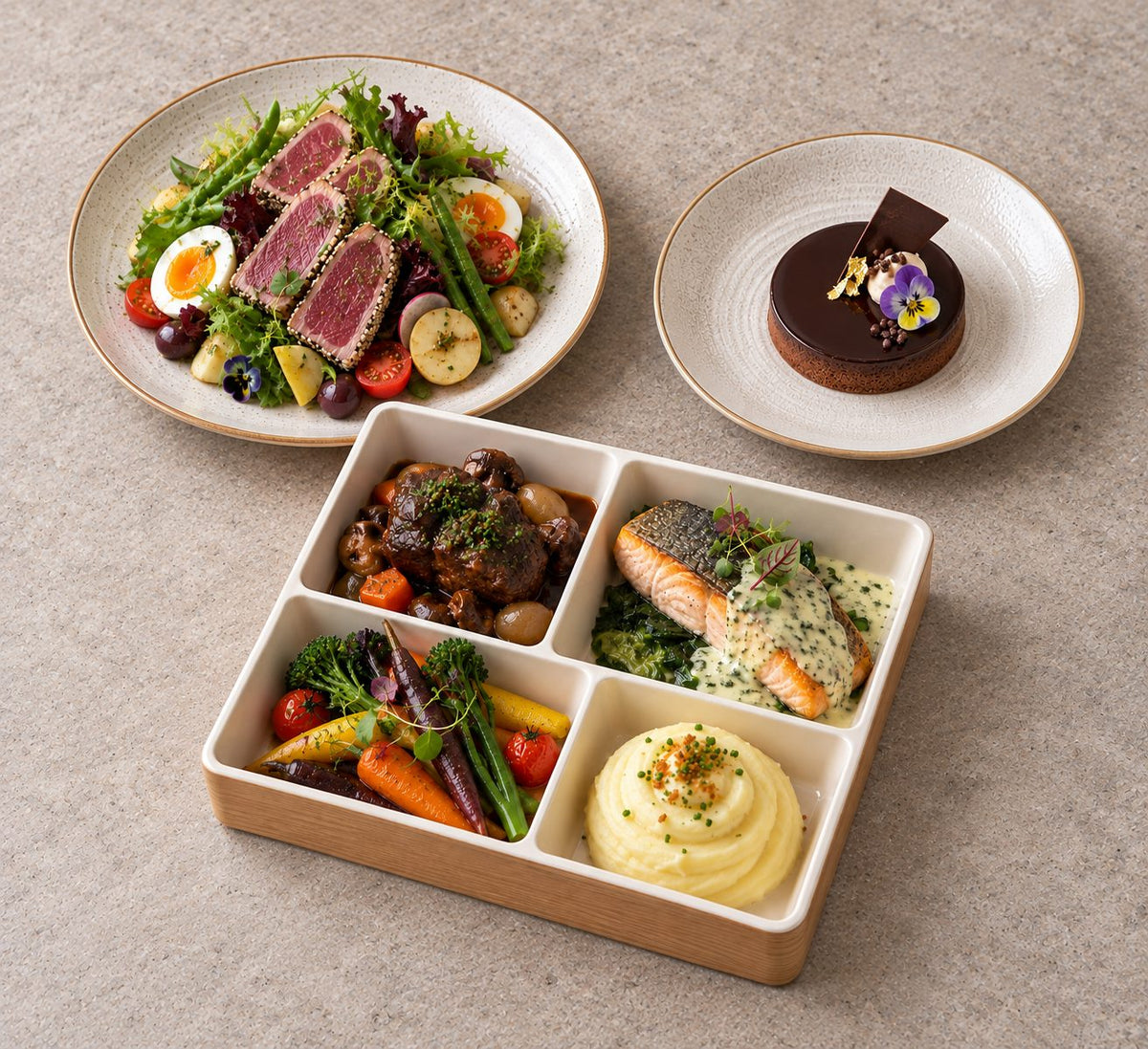 La Table Française with tuna tataki niçoise salad, french beef cheek bourguinon, tasmania salmon with sorrel beurre blanc. Cuseho bento catering, Singapore