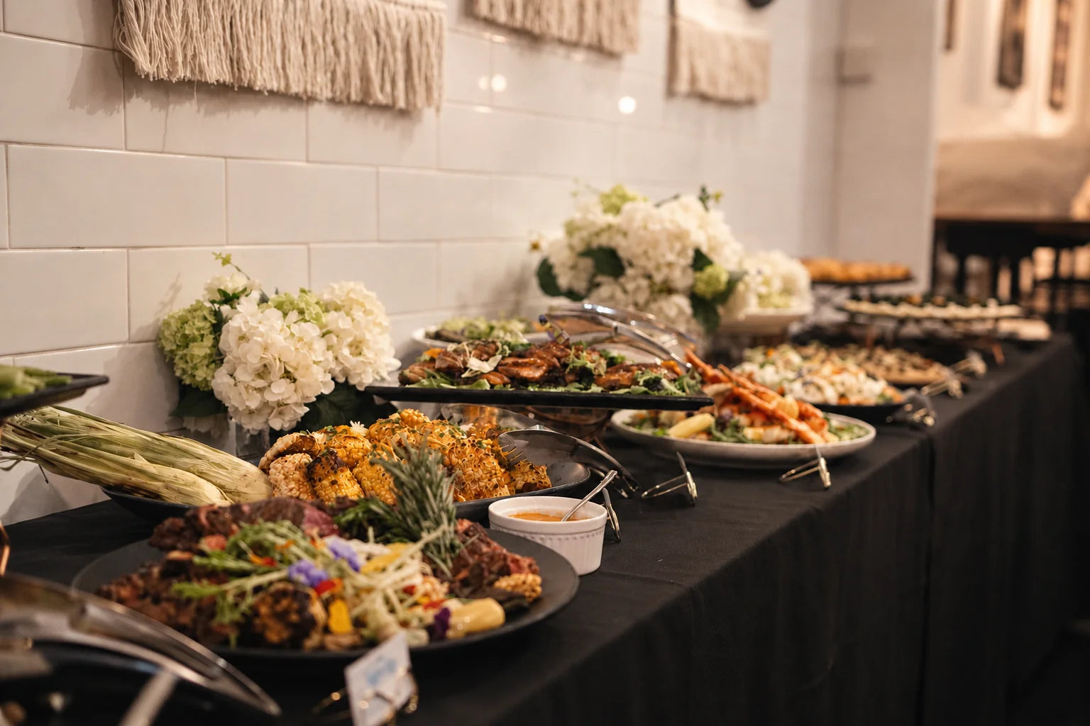 Asian dishes and fresh flowers laid out for a family gathering at home. Cuseho mini buffet catering, Singapore