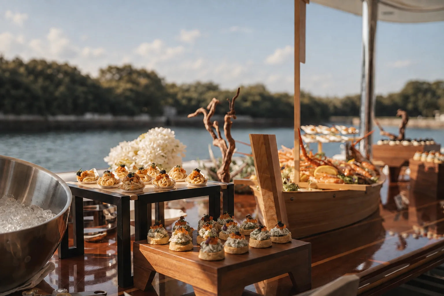 Canapés on wooden stands set up for a waterfront reception. Cuseho canapé catering, Singapore