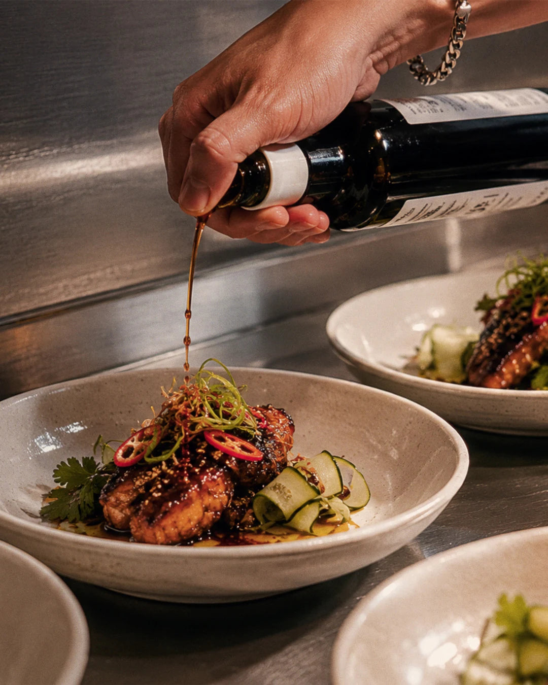Cuseho dish being finished with sauce before serving
